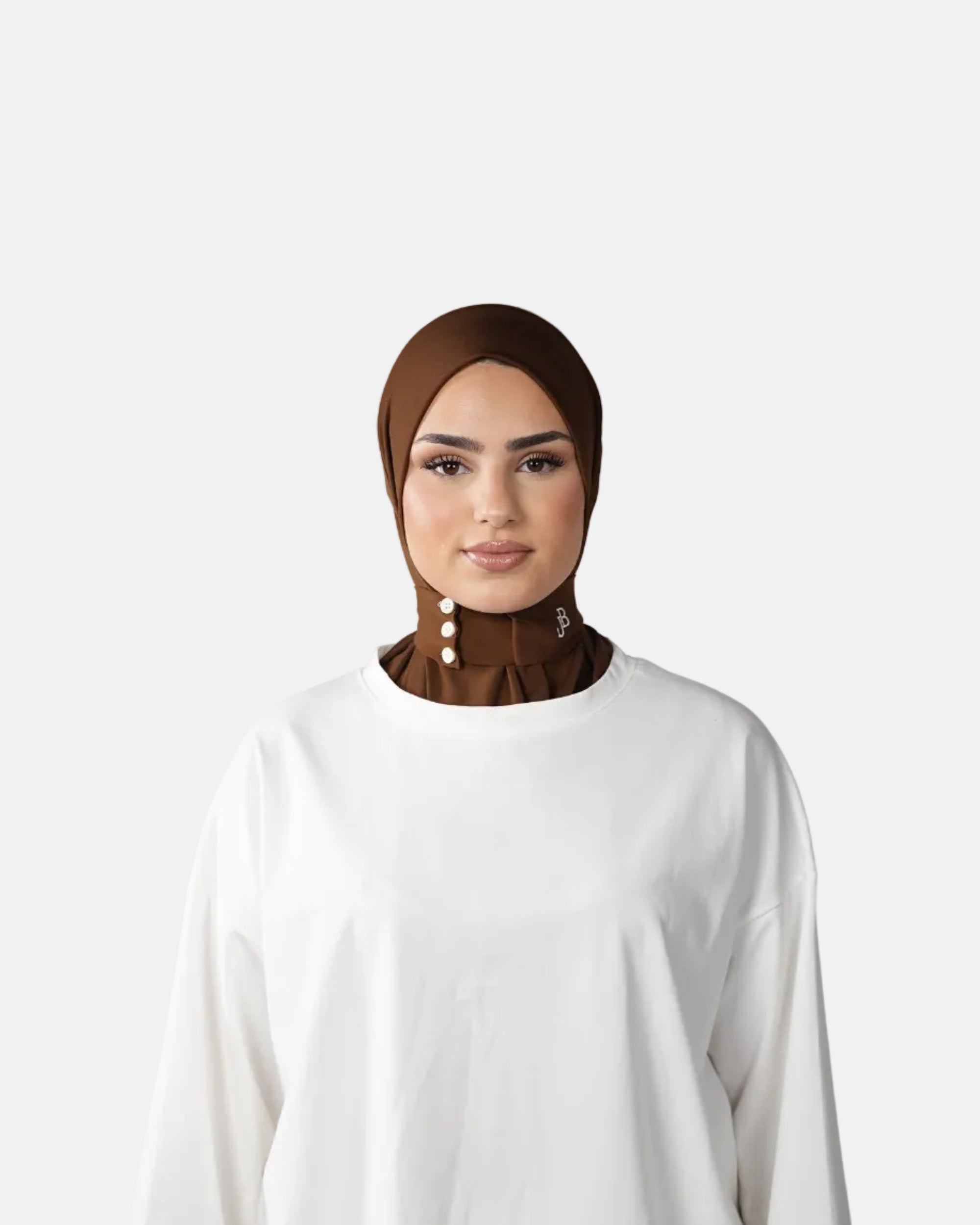 Woman wearing a brown hijab and white outfit against a gray background
