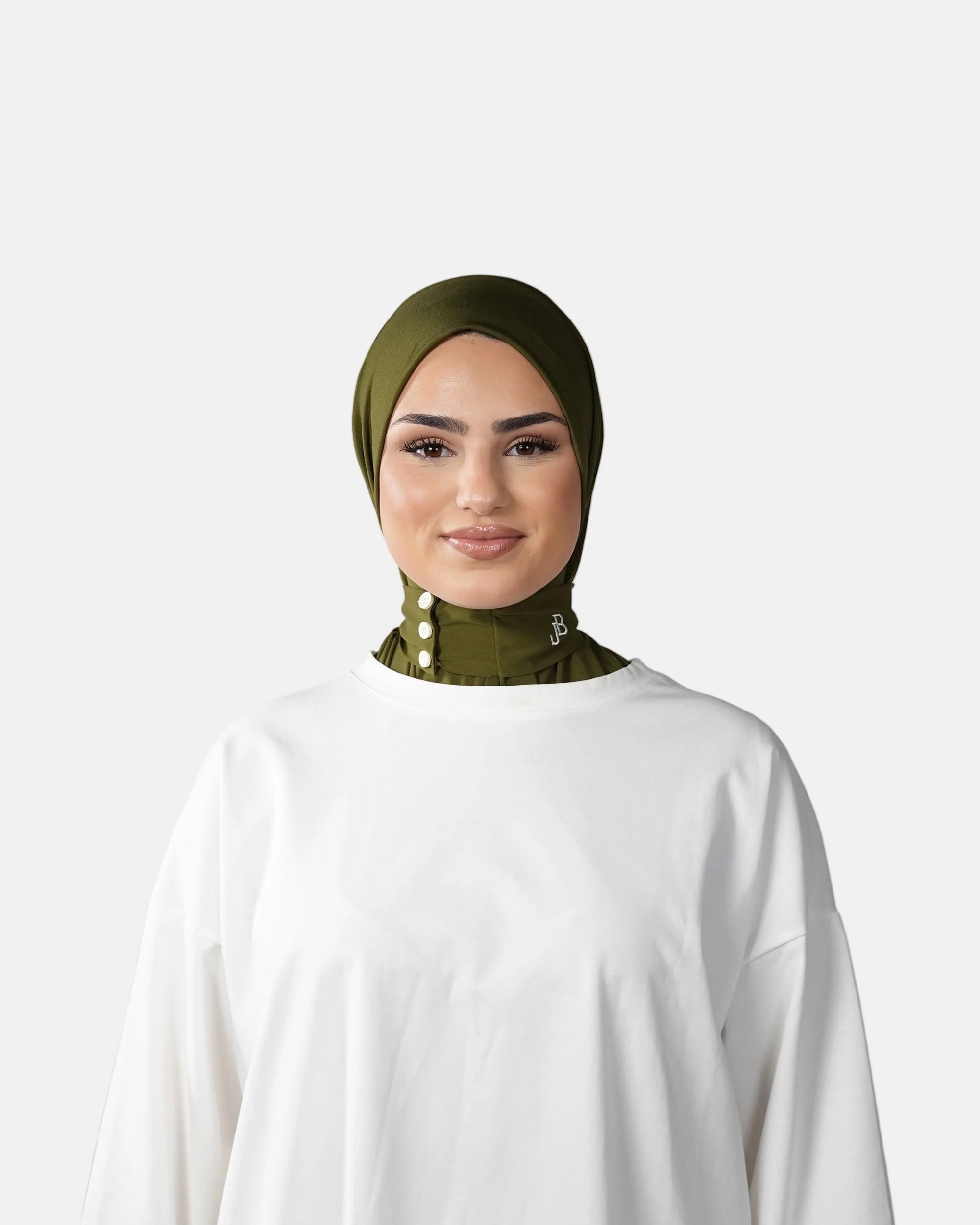 Woman wearing a green hijab and white outfit on a gray background